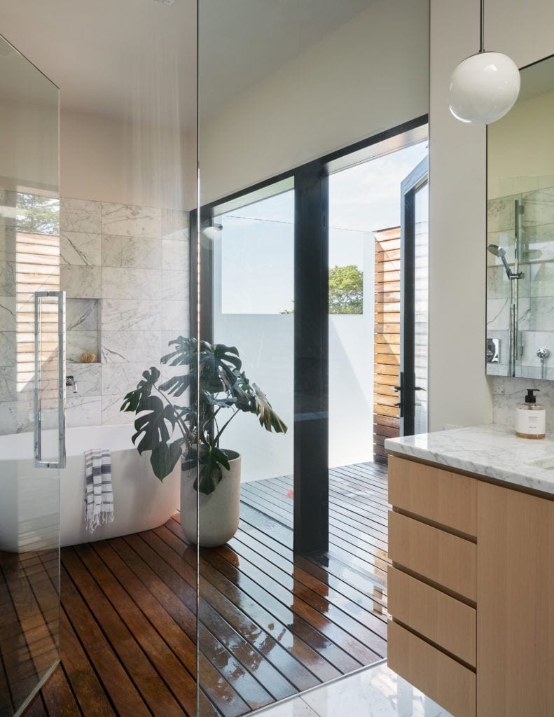Calming contemporary bathroom space inside the Fauntleroy Residence feels private without sacrificing natural light.