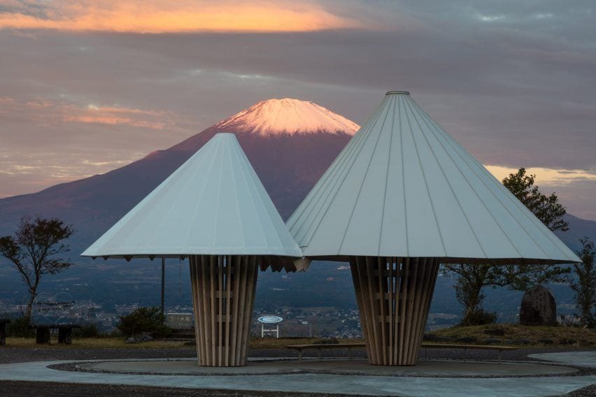 Close-up view of Kengo Kuma's Mt. Fuji-inspired public toilets in Japan, with the actual mountain visible in the background.