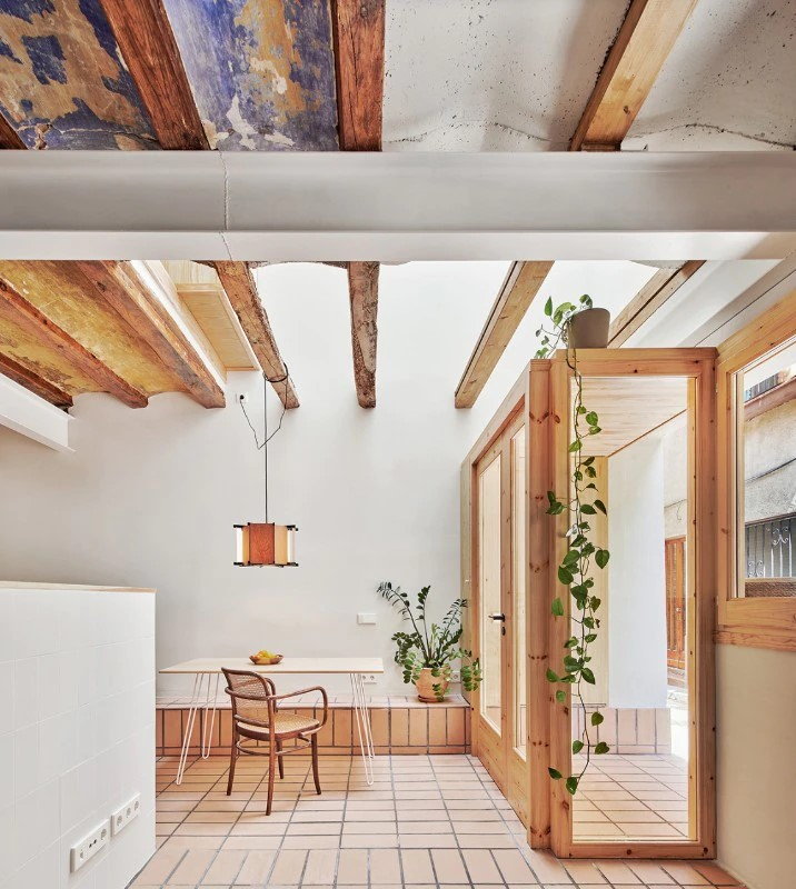 Sunny dining area inside the Twobo-restored 5x5-meter home in Barcelona.