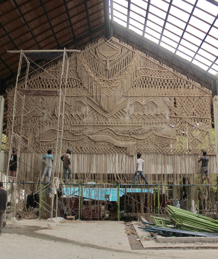 Local artisans work on bamboo scaffolding to finish Agnes Hansella's intricate macrame wall hangings for Locca Beach House Bali.