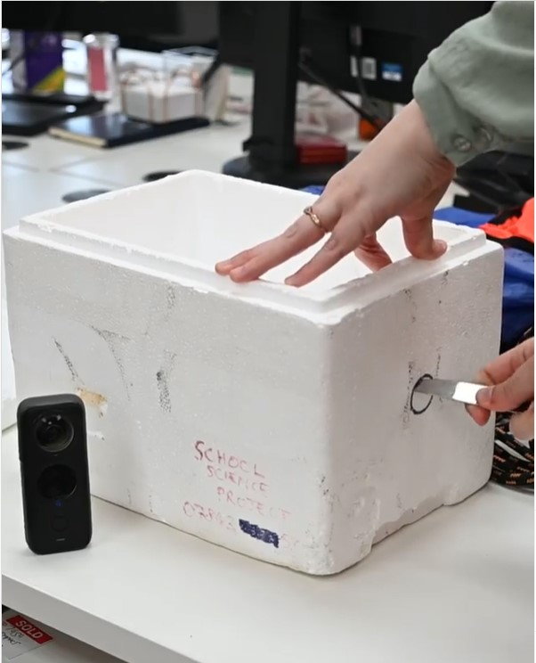 St. Bridget's students cut holes in the styrofoam box that would eventually become their weather balloon camera.
