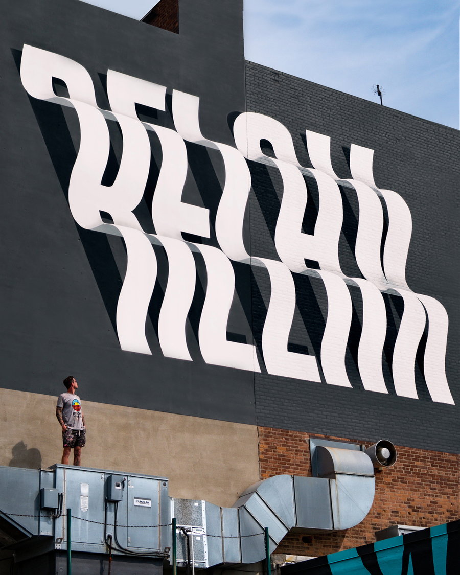 In this Ben Johnston mural, the large white text seems to ripple up and down across the wall it's been painted on. 