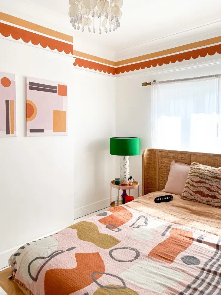 Fun orange wallpaper border lines a kitschy contemporary bedroom space.
