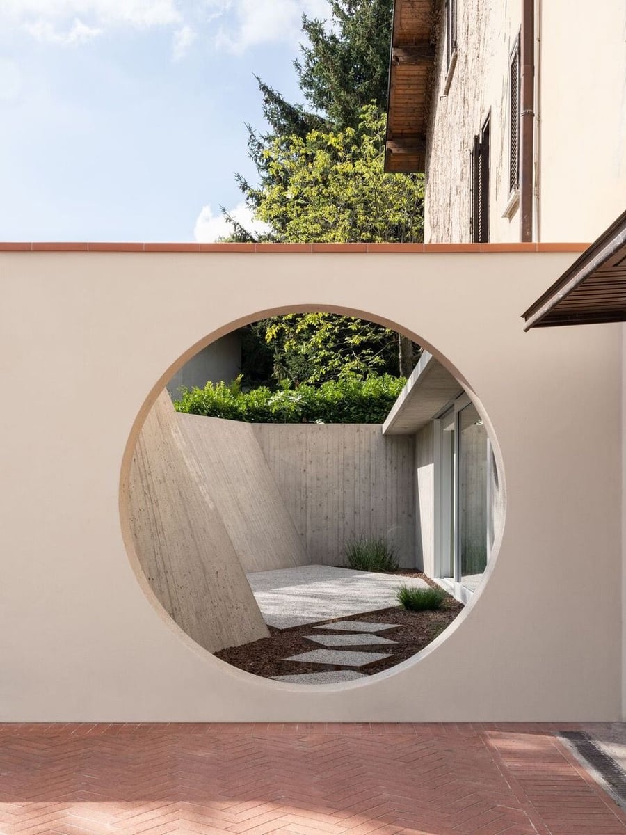 Circular entrance leads to the sunken courtyard just outside the home's formerly unused basement area. 