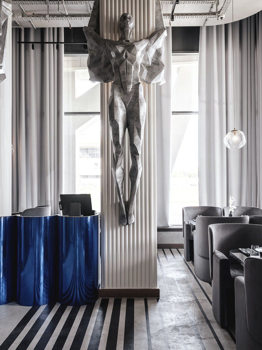 The imposing statues hanging from the café's columns are reminiscent of bold Soviet imagery. 