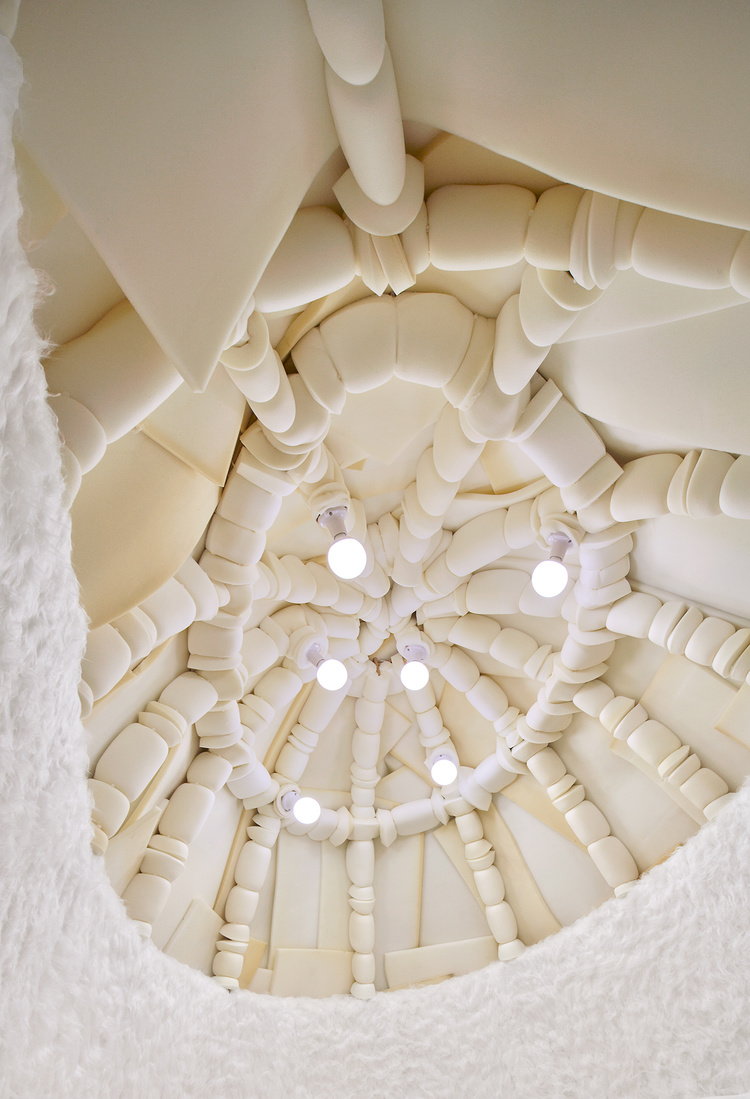 Warm globe lights hang from the ceiling of the Takk-designed Igloo Room.