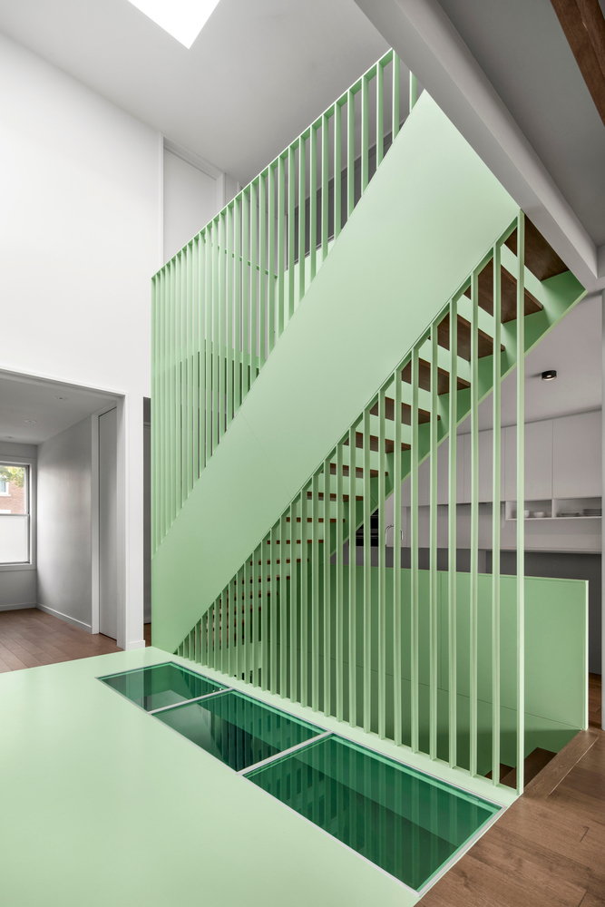 A lovely mint green staircase sits at the heart of the renovated Victoria Residence.