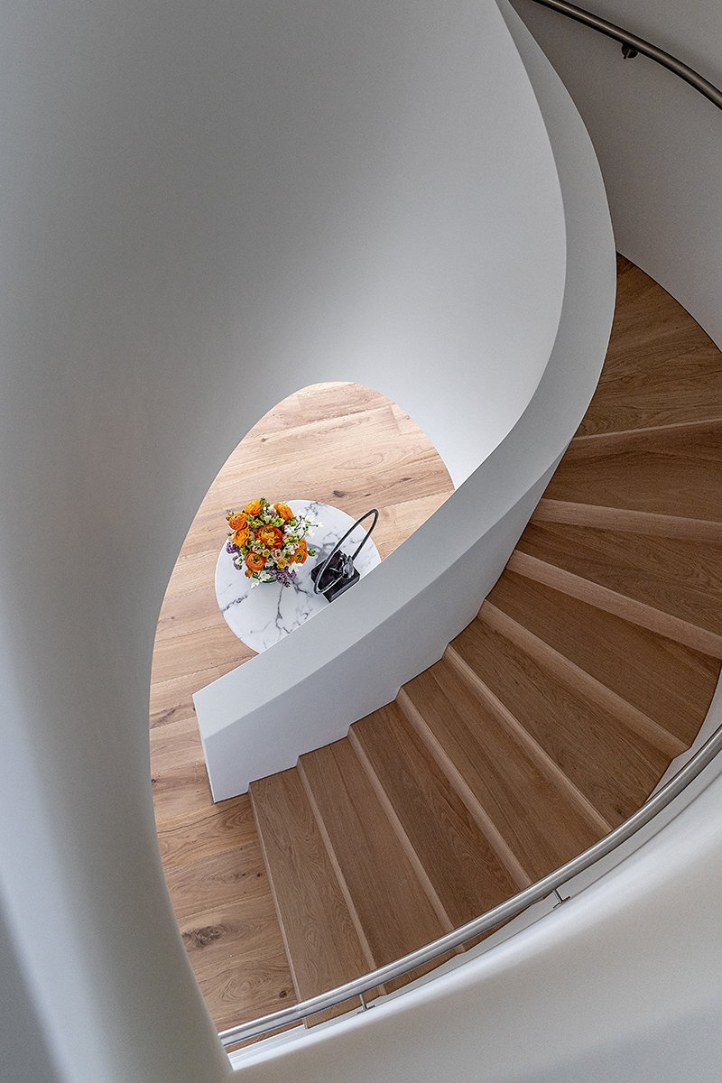 Modern spiral staircase inside a luxurious Prospect Place home.