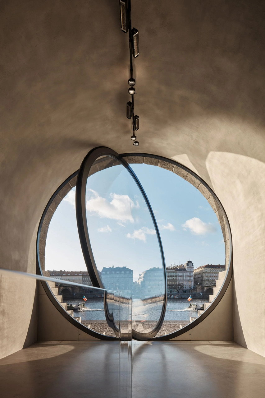 Interior view of a large Vltava River Vault window pivoting open to the outside world. 