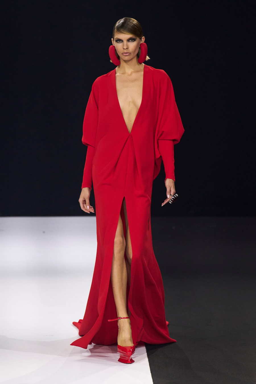 Stéphane Rolland model sports a candy apple red dress and platform shoes at Paris Fashion Week 2022.