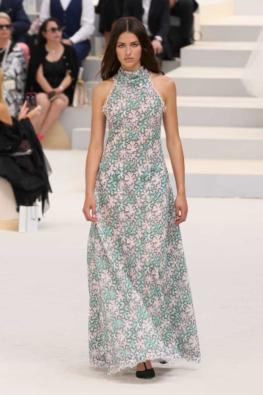CHanel model sports a retro floral-print dress for Paris Fashion Week 2022. 