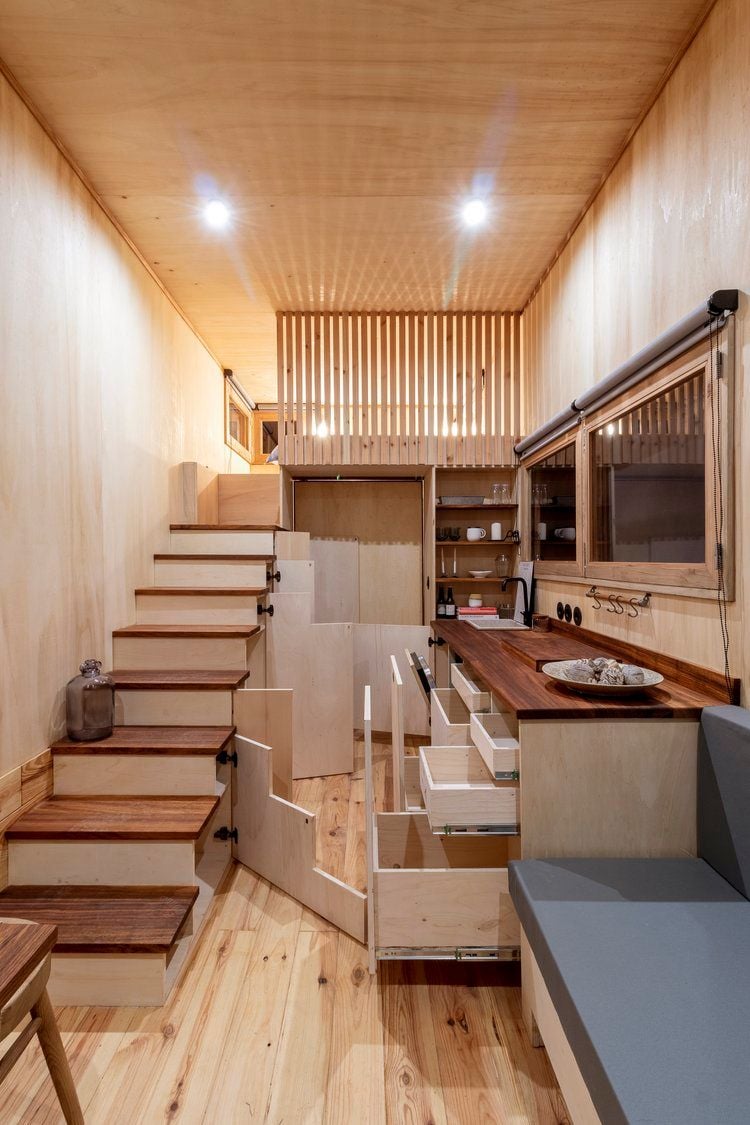 Full view of the Madeiguincho-designed Adrage House's ample wooden interiors, with all hidden storage compartments open and pulled out.