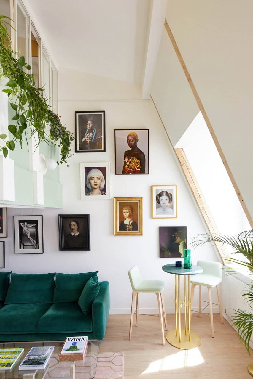 Artwork and greenery hangs high up on the walls of this Manuelle Gautrand-renovated 17th-century Paris apartment.  