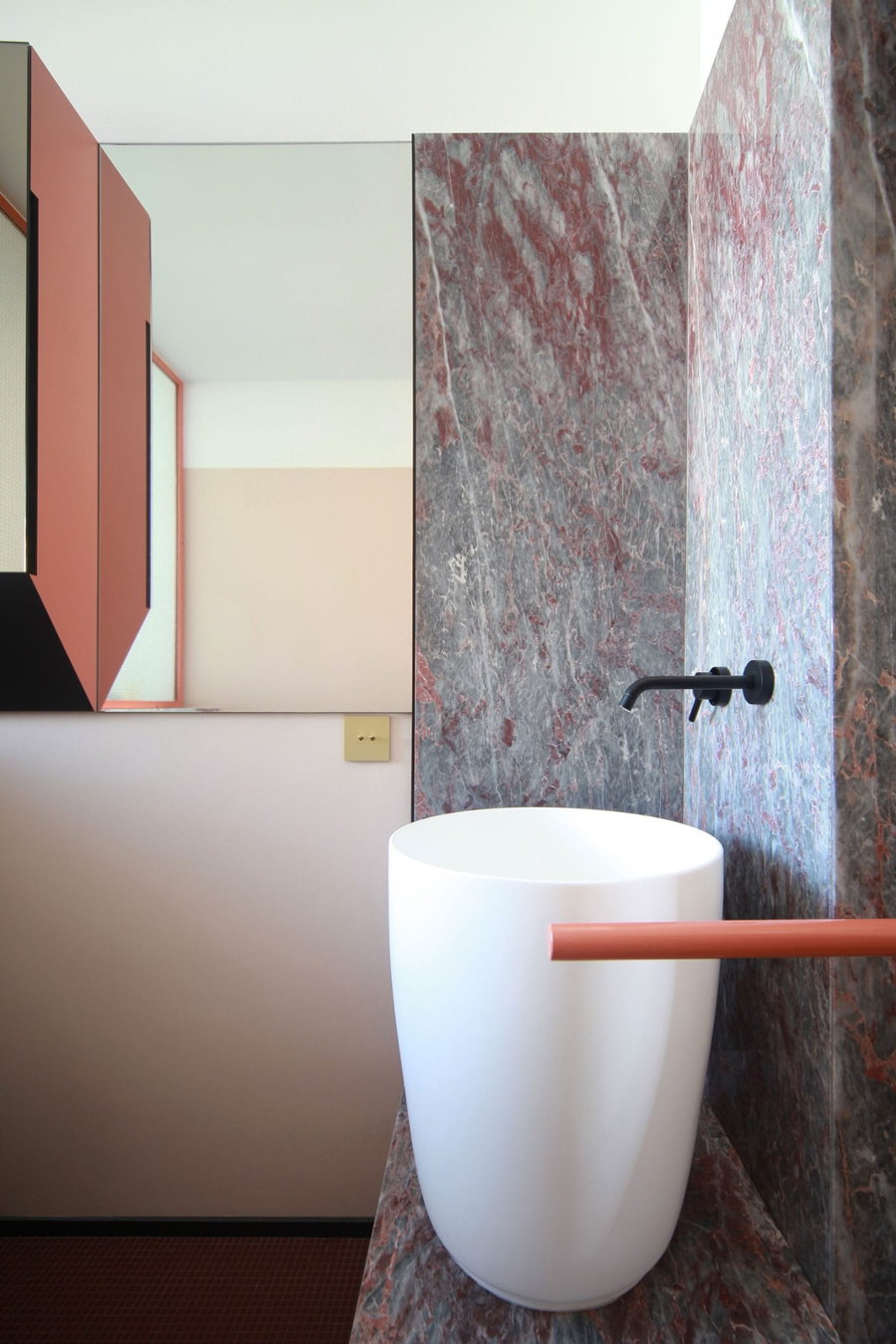 Soft pink marble adorns the bathroom inside the renovated Teorema Milanese
