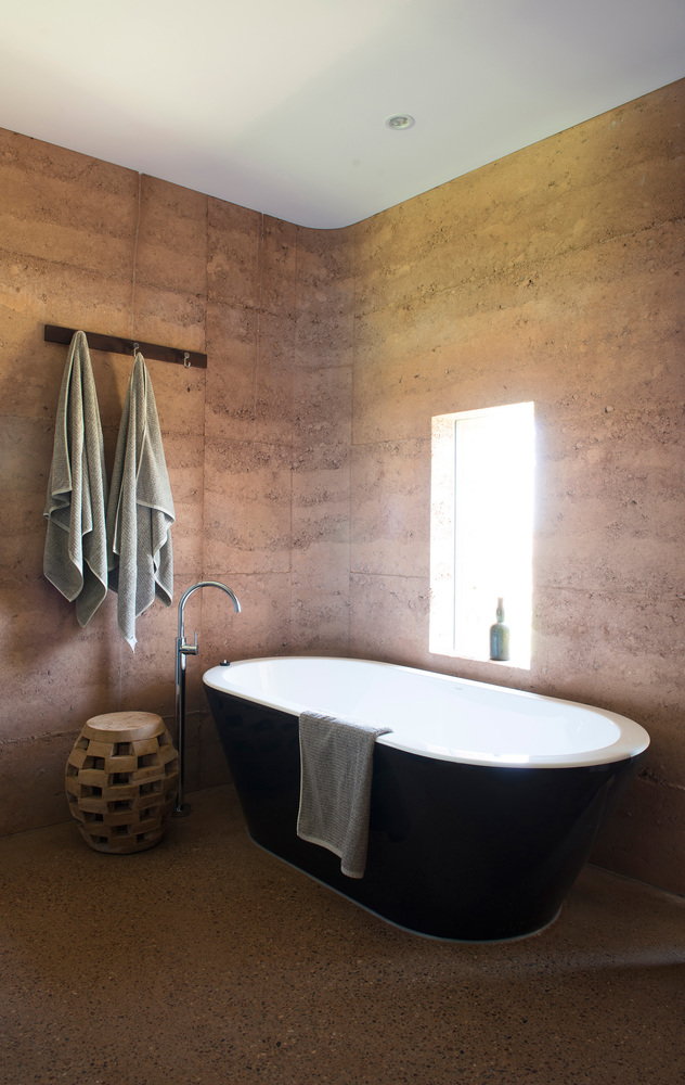 Sleek rammed earth bathroom inside one of the Great Wall of WA's 12 total guest houses, complete with a lavish oversized bathtub.