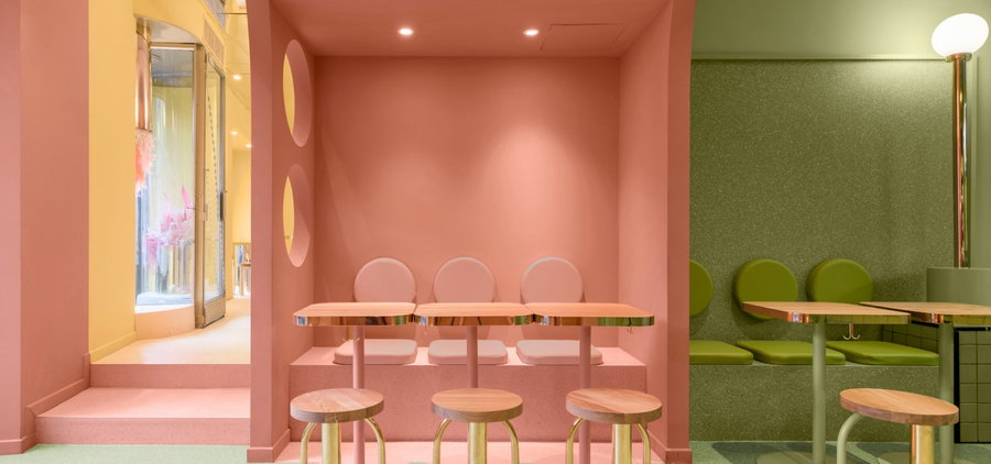 Multicolored pastel eating spaces inside the Masquespacio-designed Bun burger restaurant in Milan.