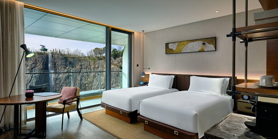 The above-ground rooms in the resort boast modern furniture and gorgeous views of the surrounding cliffs and waterfalls. 