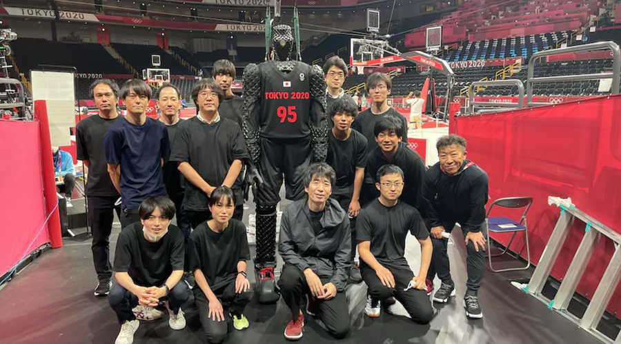 Fans pose with Toyota's CUE5 Basketball Robot