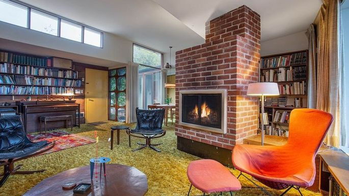 The perfectly preserved 1950's living area inside a Bentwood, Los Angeles home, complete with a classic brick fireplace.