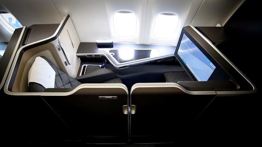 First-class pod onboard a British Airways flight, with the doors fully closed.