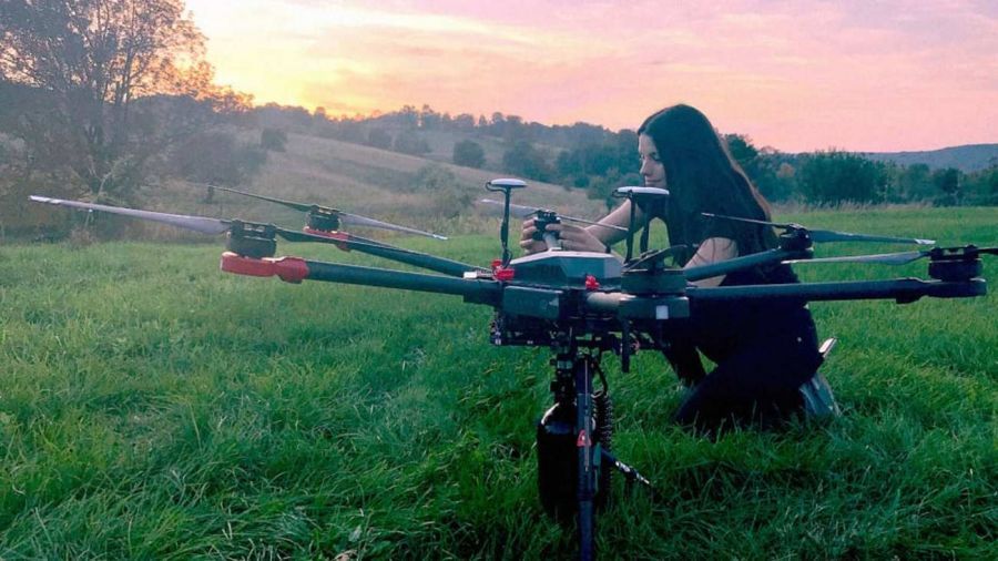 Flash Forest  team member readies a drone for take-off. 