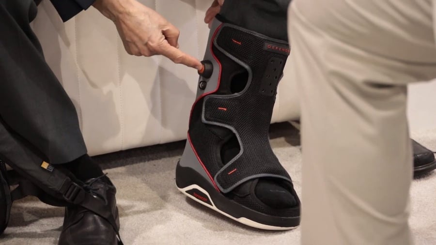 Patient pushes button on the Foot Defender boot to inflate an internal air sac. 