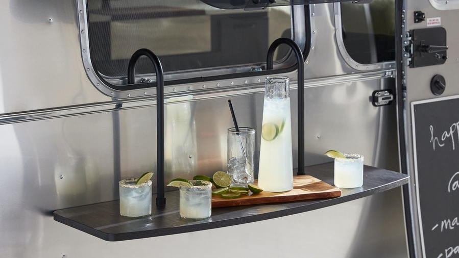 Fold-out cocktail table on the outside of the Airstream X Pottery Barn travel trailer.