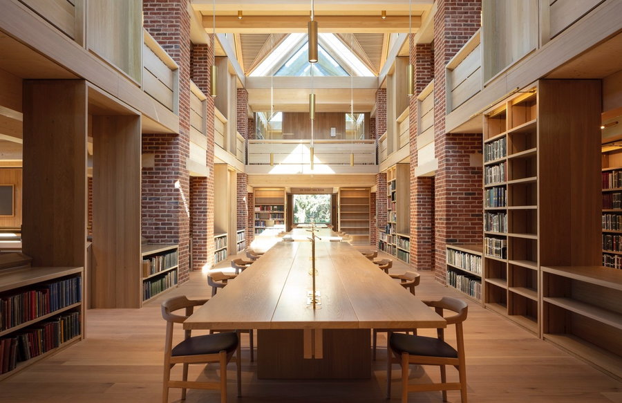 Warm wooden study hall space inside the New Library in Magdalene College in Cambridge, UK. 