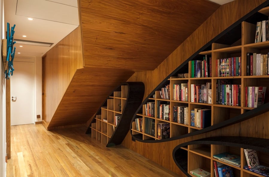 A corridor inside the Wave House, complete with several wooden shelves for storage 