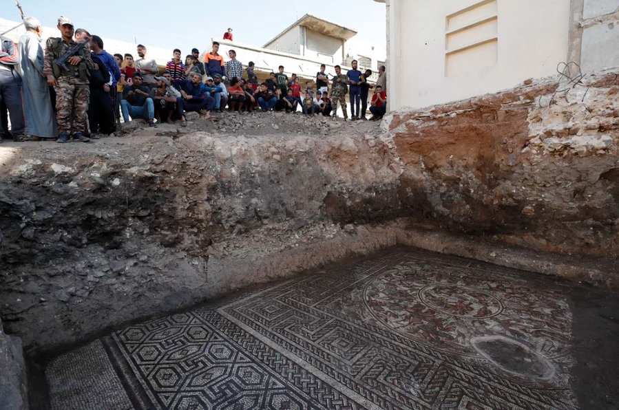 Crowds gaze down at the unearthed 1,600-year-old mosaic in Ratsam, Syria.