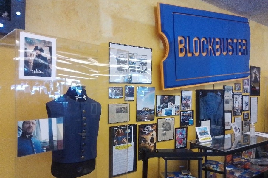 Famous movie props and costumes proudly hang on display at the back of the Blockbuster Bend store.