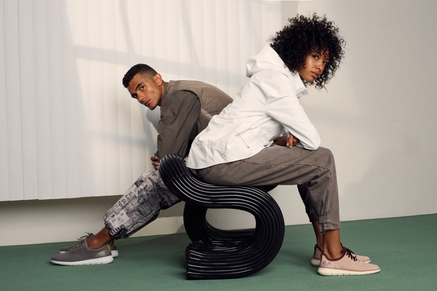 Man and woman sit on a curving black 