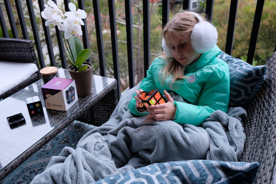 Young girl plays games on her WowCube entertainment system.