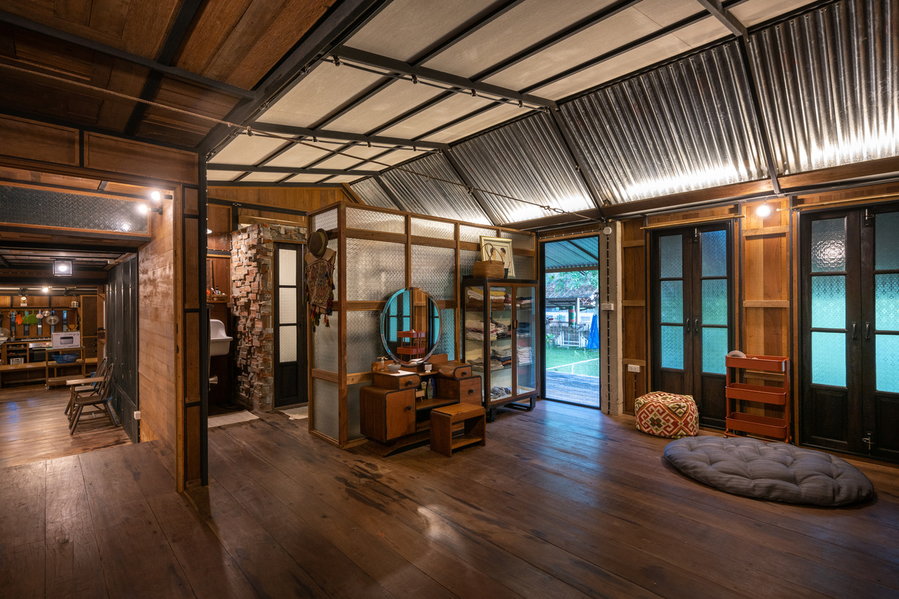 Small decor pieces adorn the Kha-Nam Noi house's cozy reclaimed wood interiors.
