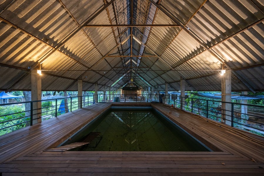 Large, covered swimming pool adds to the Kha-Nam Noi house's lush tropical vibe.