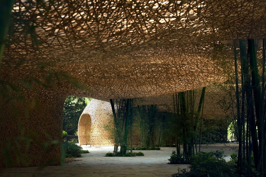 A photo taken from the heart of the pavilion, with a nest-like lantern structure visible in the distance.