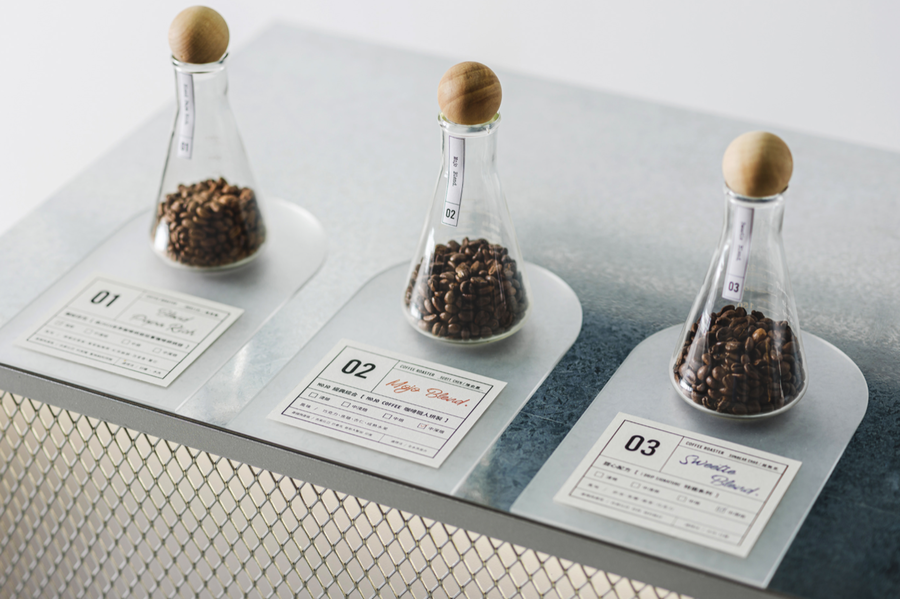 Coffee beans from all over the world sit in crystal clear test tubes inside iDrip's Smart Pour-Over Coffeemaker Exhibition Space.