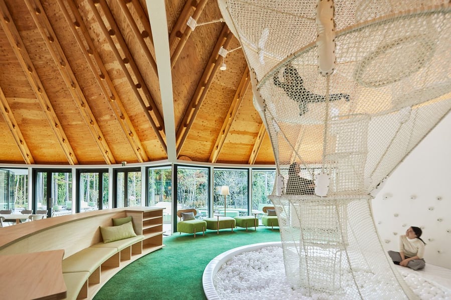 Kids play inside a large net structure inside the PokoPoko Fairytale Club House 