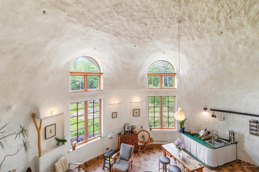 Large arched windows and tall ceilings give the dome home's already-big living room an even bigger feel. 
