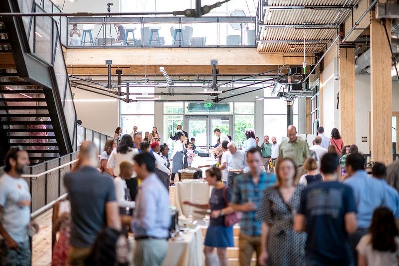 Students and faculty members move throughout the simple, sustainable interiors of the Kendeda Building.