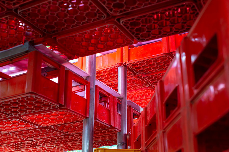 Close-up of the red plastic crates that serve as the modules for Parisauli Arsitek Studio's Kotakrat Pavilion