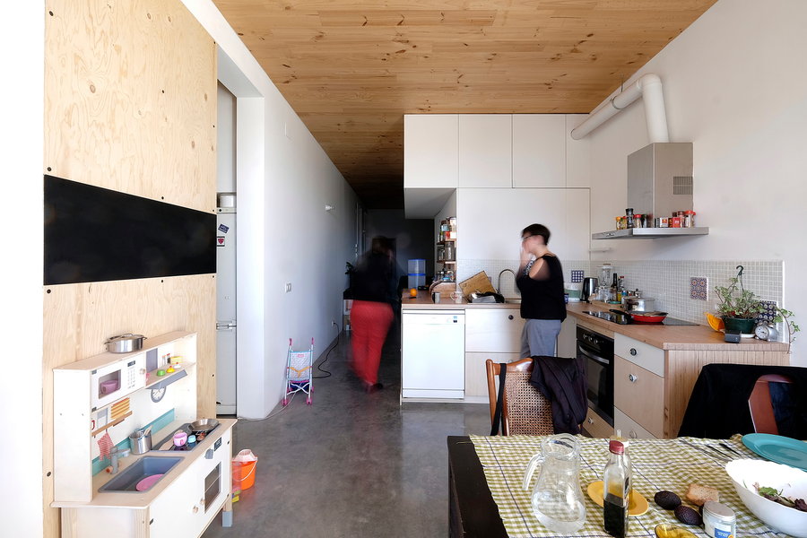 La Borda residents cohabitate in the building's communal kitchen area.