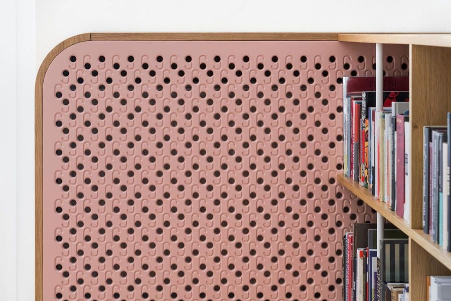 Maisonette 69 pink accent wall by a bookcase