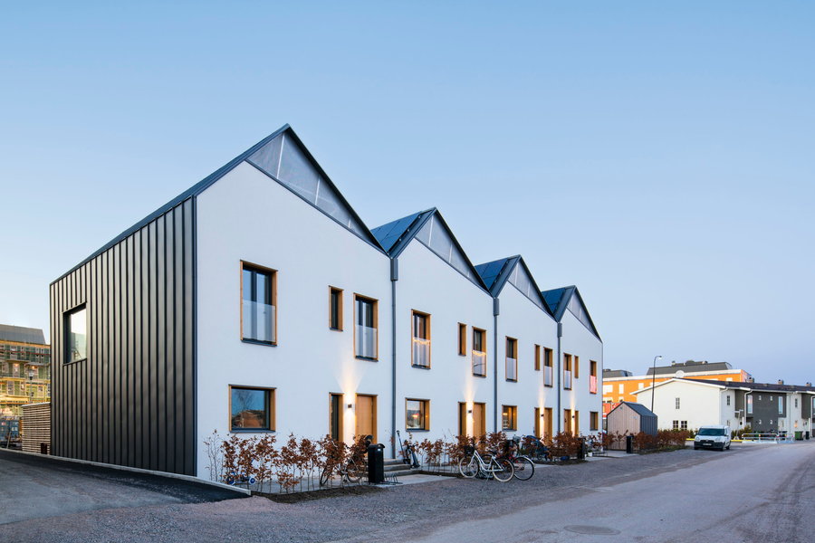 Side view of Street Monkey Architects' New Solar-Powered Prefab Row Houses in Sweden.