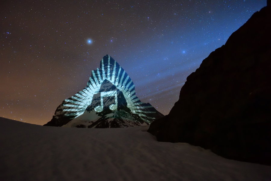 A musical note symbol beams from the peak of the Swiss Matterhorn. 