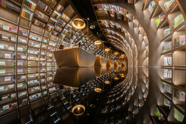 The Zhongshuge Guiyang bookstore feels like a giant light tunnel filled with books and shiny surfaces.