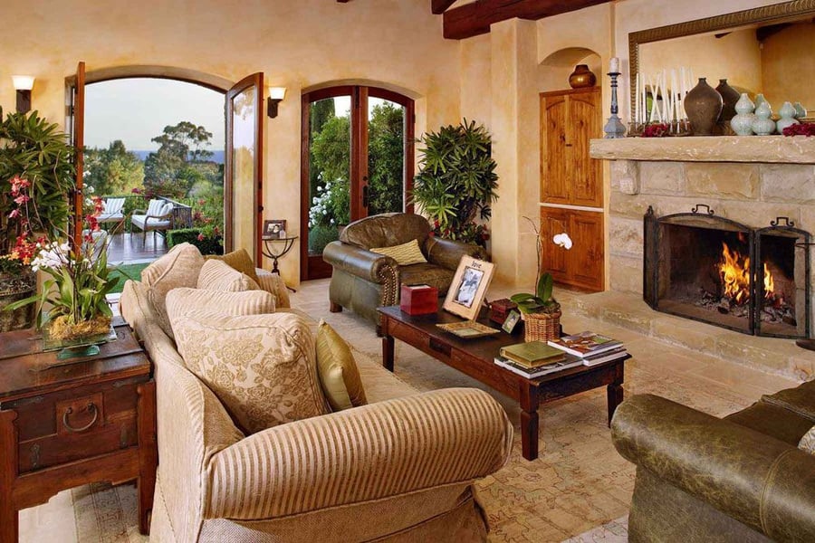 Spacious, rustic-feeling living rom decorated in traditional Tuscan style.