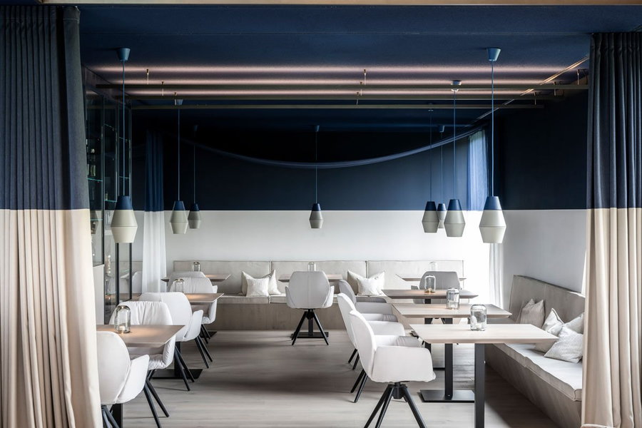 Contemporary blue-and-white dining space in Northern Italy's noa-designed AEON Hotel. 