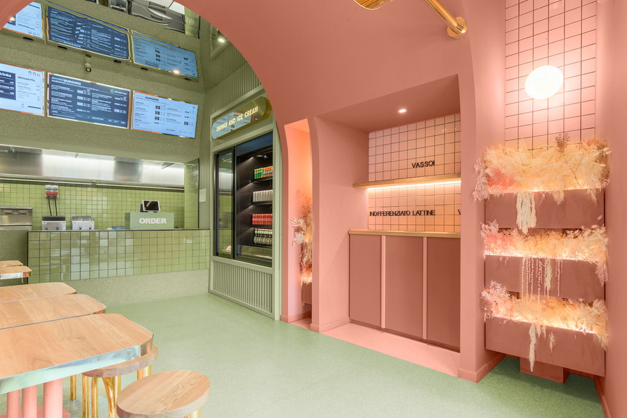 Chic serving and condiment counters covered in pastel tiles inside the Masquespacio-designed Bun buger joint.