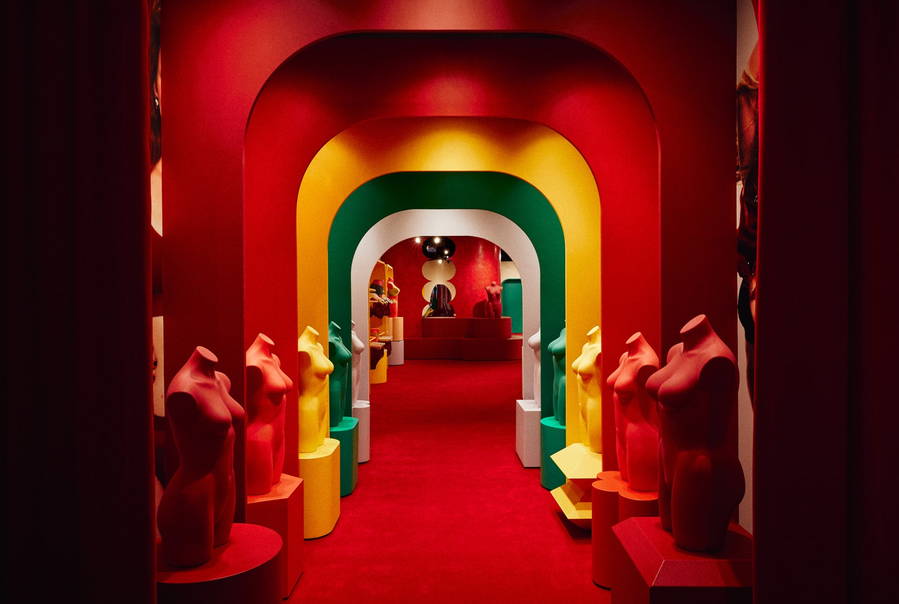 Surreal entryway of the Parade store in New York City lined with multicolored busts. 
